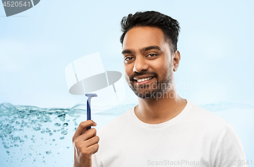 Image of indian man shaving beard with razor blade