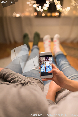 Image of close up of couple taking foot photo by smartphone