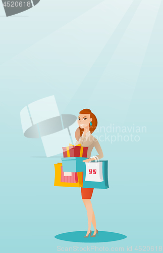 Image of Woman holding shopping bags and gift boxes.