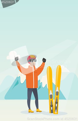 Image of Young caucasian skier standing with raised hands.