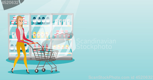 Image of Young caucasian woman with supermarket trolley.