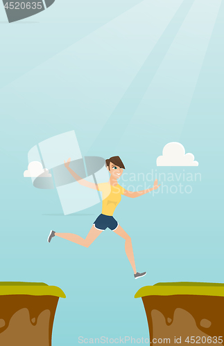 Image of Young caucasian sportswoman jumping over the cliff