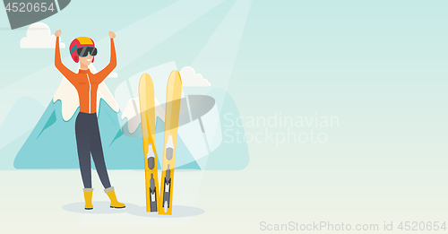 Image of Young caucasian skier standing with raised hands.