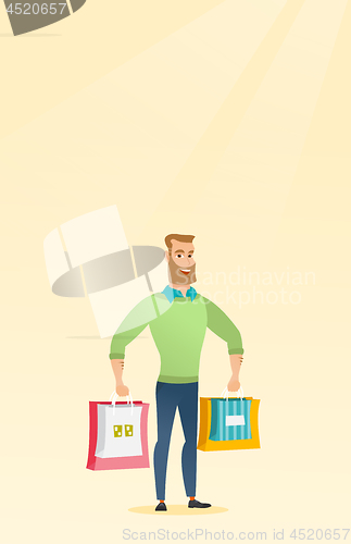 Image of Young happy caucasian man with shopping bags.