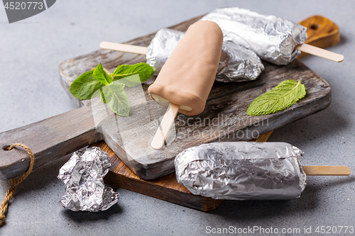 Image of Homemade popsicle on a stick wrapped in foil.