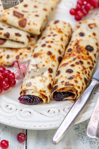 Image of Norwegian pancakes stuffed with berry jam.