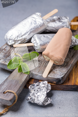 Image of Artisanal ice cream covered with chocolate.