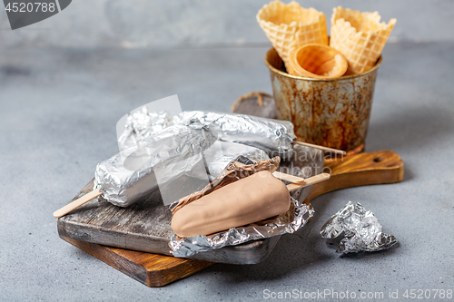 Image of Homemade ice cream with chocolate icing on a stick.