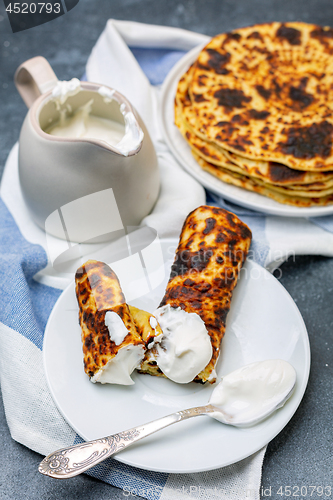 Image of Homemade potato pancakes lefse with sour cream.