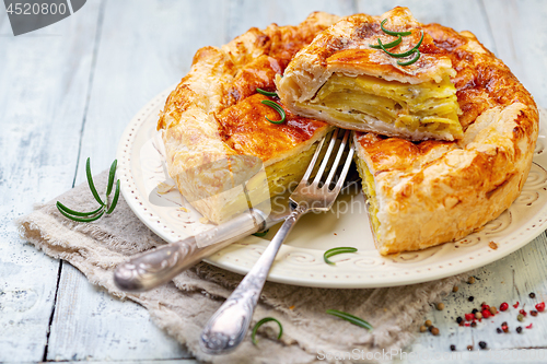 Image of Puff pastry pie dish with potatoes and rosemary.