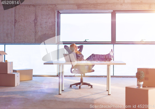 Image of young female architect taking a break on construction site