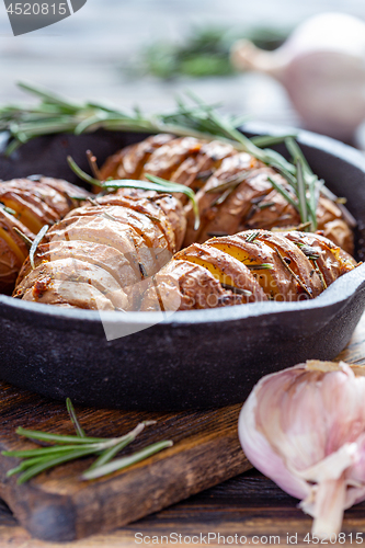 Image of Potatoes in their skins baked with rosemary.