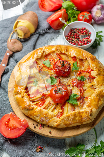 Image of Traditional pie (Galette) with potatoes and bacon.