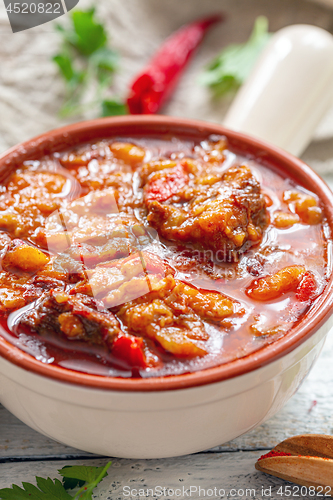 Image of Thick meat soup with potatoes and paprika close-up.