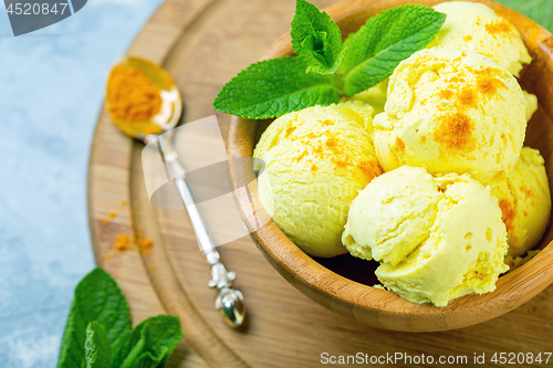 Image of Golden ice cream with turmeric closeup.