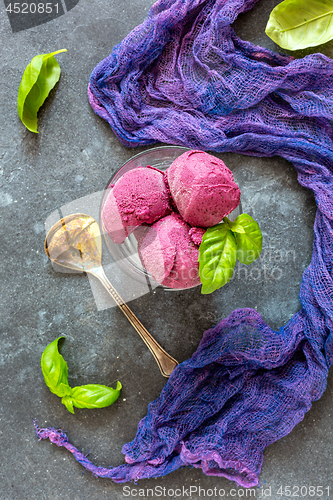 Image of Homemade blueberry ice cream with green basil.