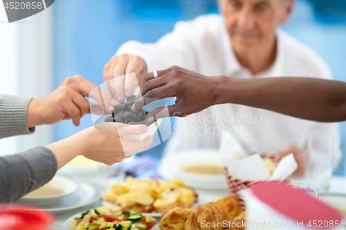 Image of modern multiethnic muslim family sharing a bowl of dates