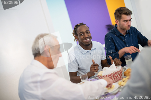 Image of black man enjoying iftar dinner with family