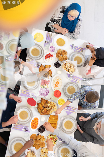 Image of top view of modern multiethnic muslim family having a Ramadan fe