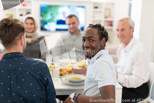 Image of black man enjoying iftar dinner with family