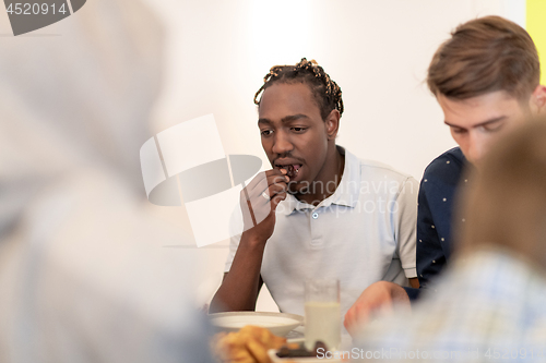 Image of black man enjoying iftar dinner with family