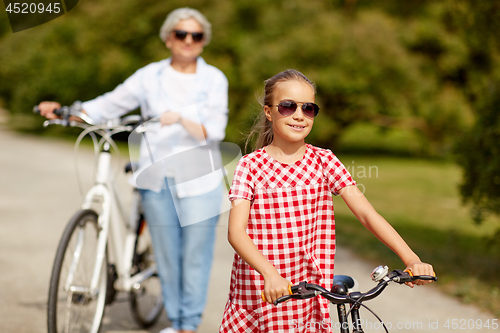 Image of grandmother and granddaughter with bicycles