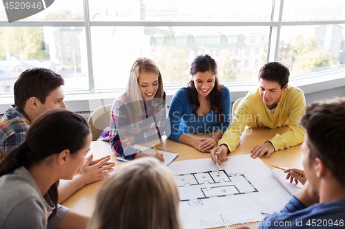 Image of group of smiling students with blueprint