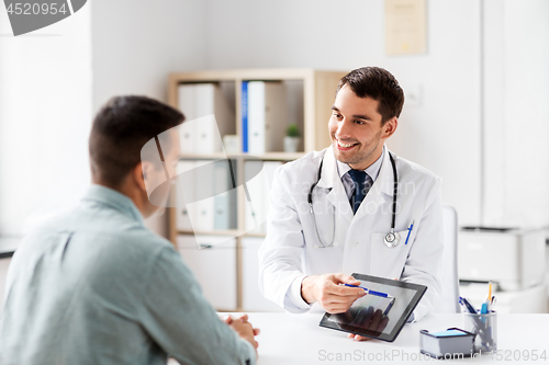 Image of doctor with tablet computer and patient at clinic