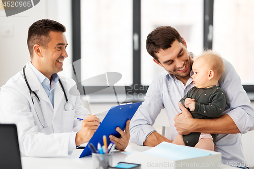 Image of father with baby and doctor at clinic