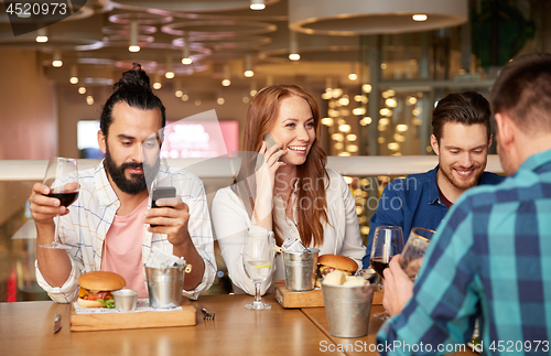 Image of friends dining and drinking wine at restaurant