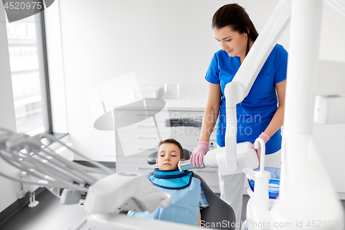 Image of dentist making x-ray of kid teeth at dental clinic