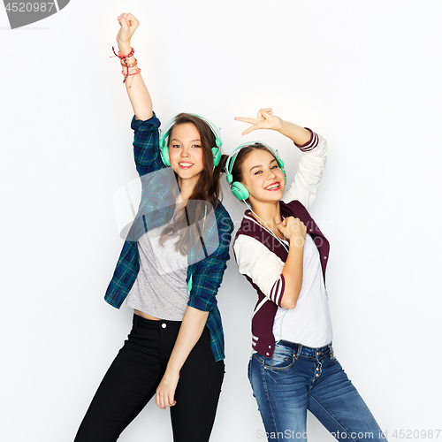 Image of teenage girls in earphones listening to music