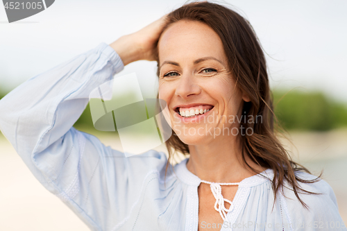 Image of happy smiling woman on summer beach