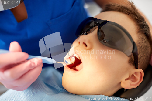 Image of boy having teeth checkup at dental clinic