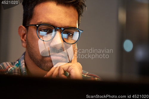 Image of close up of creative man working at night office