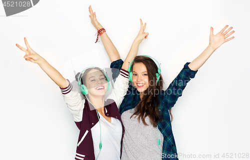 Image of teenage girls in earphones listening to music