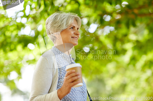 Image of senior woman drinking takeaway coffee at park