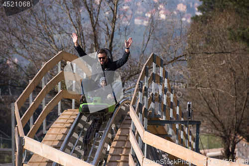 Image of father and son enjoys driving on alpine coaster