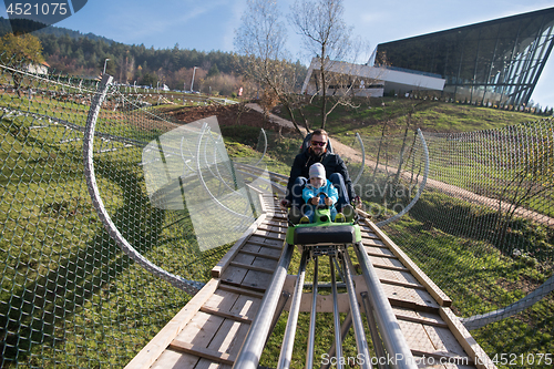 Image of father and son enjoys driving on alpine coaster