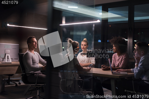 Image of Multiethnic startup business team in night office