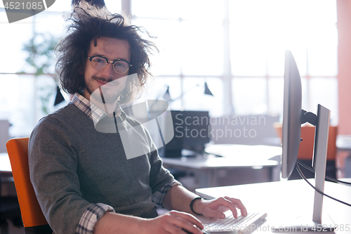 Image of businessman working using a computer in startup office