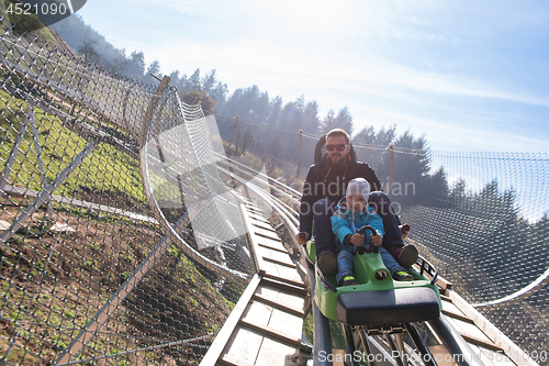 Image of father and son enjoys driving on alpine coaster