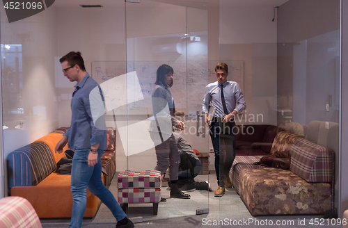 Image of software developers sleeping on sofa in creative startup office