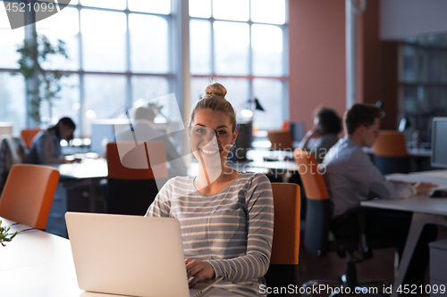 Image of businesswoman using a laptop in startup office