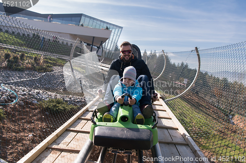 Image of father and son enjoys driving on alpine coaster