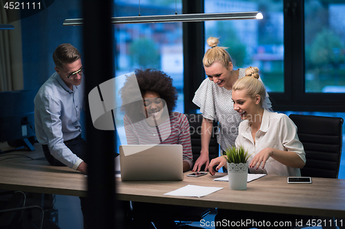 Image of Multiethnic startup business team in night office