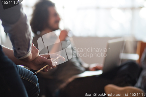 Image of Young man holding smartphone