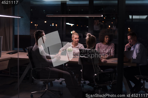 Image of Multiethnic startup business team in night office