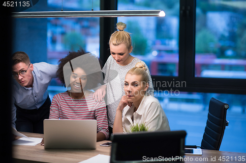 Image of Multiethnic startup business team in night office