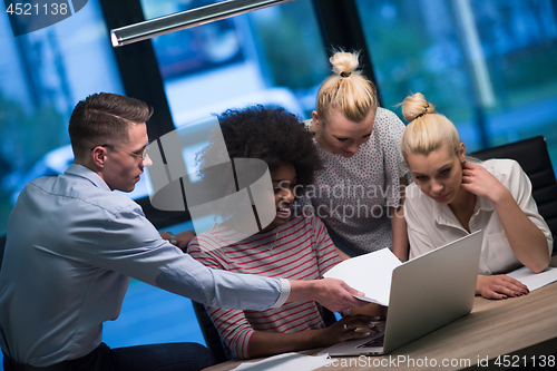 Image of Multiethnic startup business team in night office